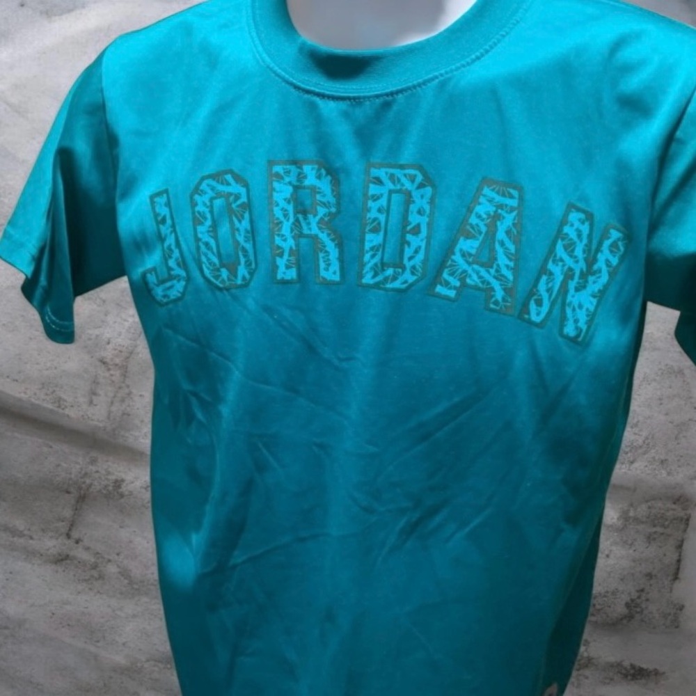 Buy 1 get one 50% off kids clothes 
Jordan Teal Tee with Iconic Logo